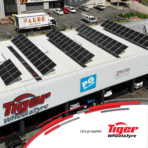 the roof of a tiger wheel and tyre store with solar panels