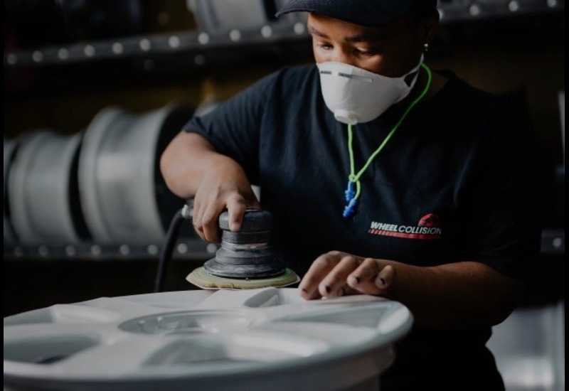 Wheel Collision technician performing a wheel repair