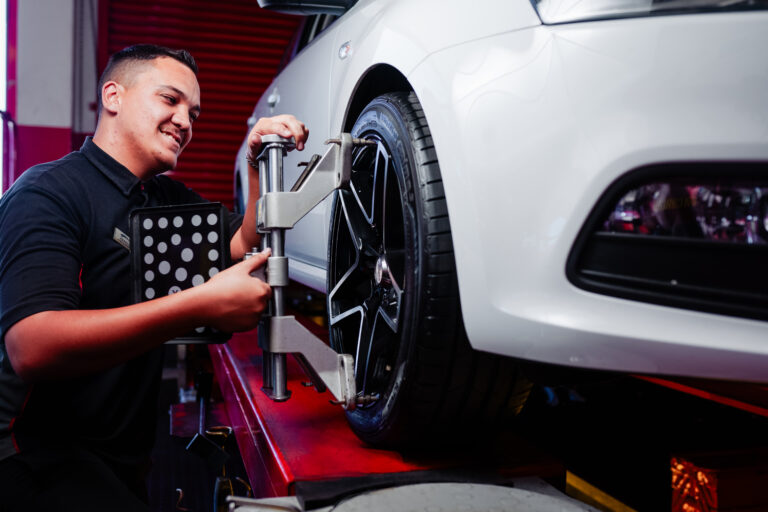 A Tiger Wheel & Tyre technician performing a wheel alignment procedure